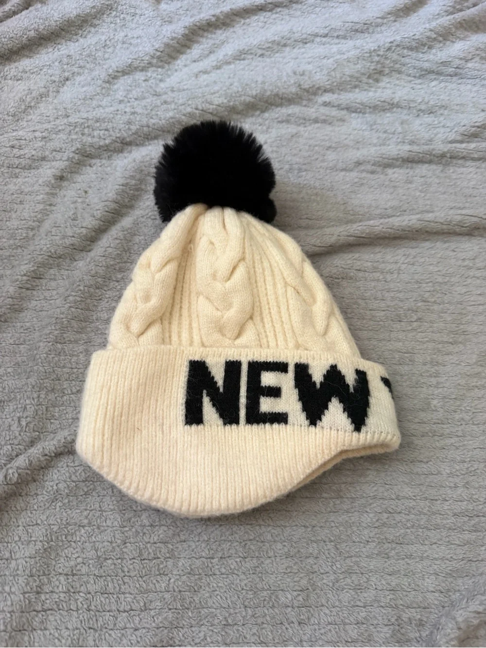 Robin Ruth Cream Cable Knit Pom Beanie with Black Lettering